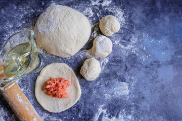 The process of making meat pies from dough with alternative gluten-free flour. Delicious homemade cakes. Slow baking, a useful home product. Copy space. Top view.