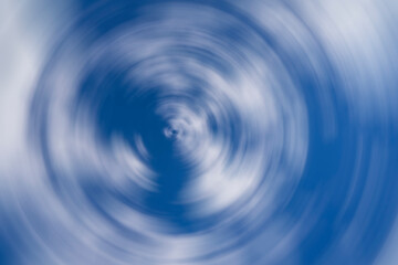 Abstract blue background. Blue, light blue, white. Radial blur. Circles on the water. Colors swirl in a circle.