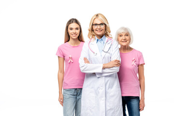 Obraz premium Doctor looking at camera near women with pink ribbons on t-shirts isolated on white