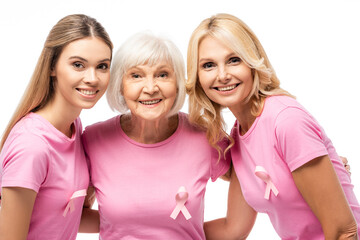 Women with pink ribbons on t-shirts hugging isolated on white