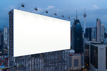 Blank white road billboard with KL cityscape background at night time. Street advertising poster, mock up, 3D rendering. Side view. The concept of marketing communication to promote or sell idea.