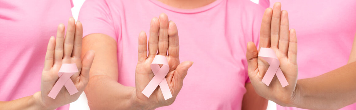 Horizontal image of women showing breast cancer awareness ribbon on palms isolated on white