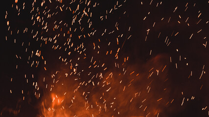 close up of sparks from fire, sparks on black background, extravaganza of fire, magic with sparks.