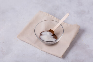 Ground coffee, sugar in a transparent bowl.