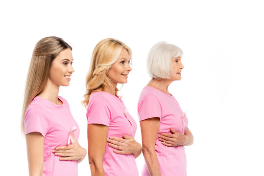 Women in pink t-shirts touching breasts isolated on white, concept of breast cancer