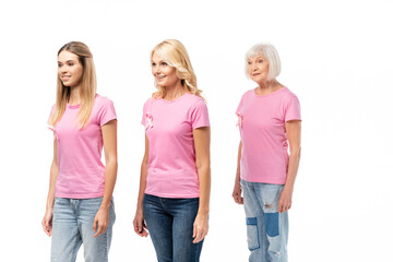 Fototapeta premium Women with breast cancer awareness ribbons looking away isolated on white