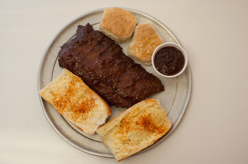 BBQ ribs with garlic bread and biscuits