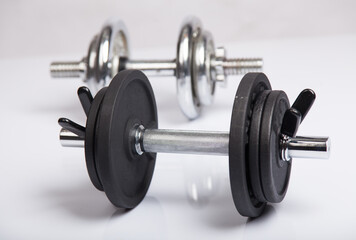 Obraz na płótnie Canvas Dumbbells with barbell discs for workout. Fitness, sport and healthy lifestyle concept.