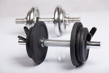 Dumbbells with barbell discs for workout. Fitness, sport and healthy lifestyle concept.