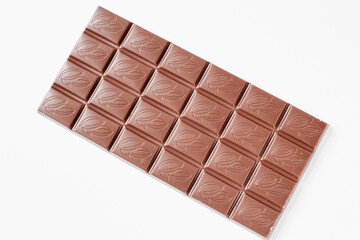 Milk chocolate bar isolated on white background