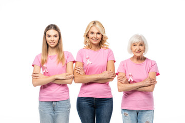 Obraz premium Women with pink ribbons of breast cancer awareness and crossed arms looking at camera isolated on white