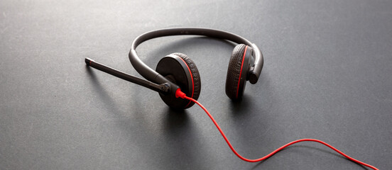 Headset on black background. Call center, home office, customer service support, help desk