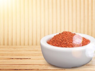 Paprika powder in a ceramic bowl on the desk