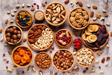 Various Nuts and dried fruits in wooden bowls.