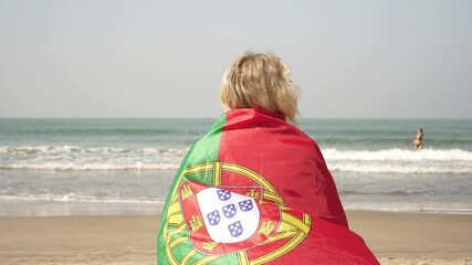 Woman on a tropical beach with the flag of Portugal on the background of the sea - Powered by Adobe