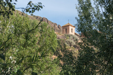 Fototapeta na wymiar tower of a church among vegetation