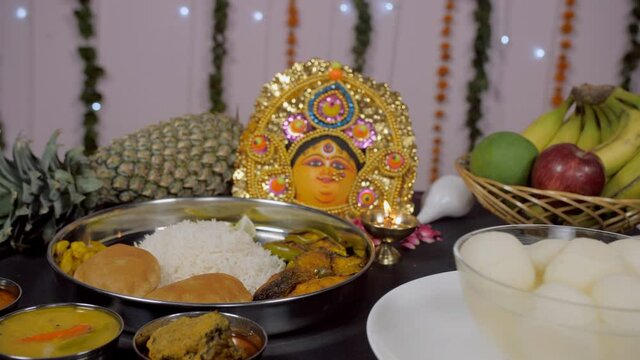 Traditional Bengali thali with a bowl of Rosogolla during Durga puja celebration. Close-up shot of regional food from West Bengal served as Bhog/Prasad for festival