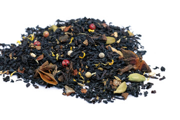 Black tea with spices and herbs to boost immunity. Masala tea with cardamom, cloves and peppers on a white plate. Dry black tea