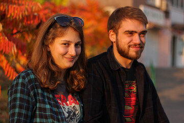 Couple in autumn. Portrait of couple. Couple in love. Man and woman at the street. Couple are hugging.