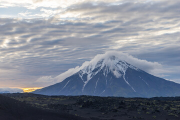 Fototapeta premium At sunrise, the cone of the Big Udina volcano