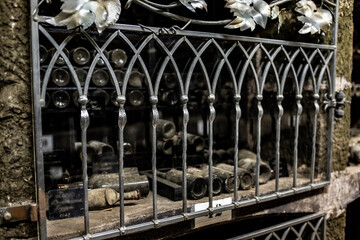 old expensive wine in bottles is stored in special niches and covered with special grates in wine...