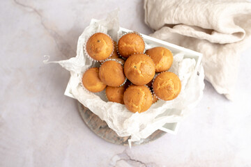 Mini muffins in paper cupcake holder on the wooden tray
