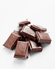 Milk chocolate pieces isolated on white background from top view, close up a chocolate bar isolated on white background