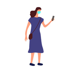 A woman in a blue dress with a phone wearing a protective mask.