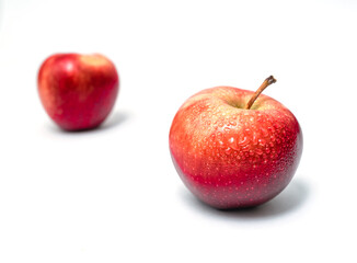 Two apples isolated. Sweet delicious dessert. Side view. With water drops. Partial blur.