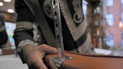 cinematic shot of the barber while fixing his chair