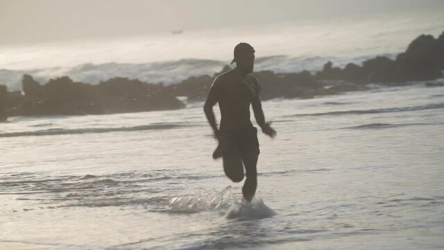 free man running along seashore
