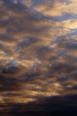 Fototapeta premium Clouds in the blue sky in the evening, during autumn, warm colours - background.