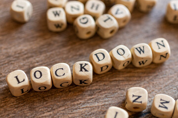 Lockdown of the economy /  coronavirus Covid 19 / letters on the wooden cubes