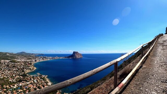 Calpe  coast and penon de ifach Penyal d'Ifac Natural Park from path above the city in the Morro de Toix. Tourists visit Calp and  View of Calp coast from a path above sea level.