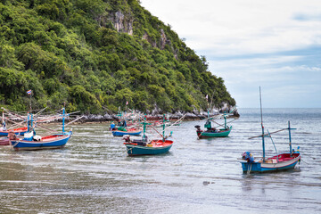 Fototapeta na wymiar Small fishing boats made from wood on the beach,Fishing boats in the sea in Thailand