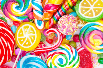 Fototapeta na wymiar Colorful lollipops and different colored round candy. Top view.