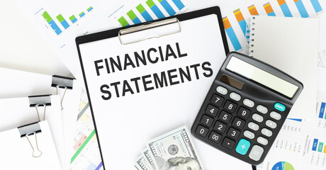 Financial Statement text written on a notebook with documents and calculator
