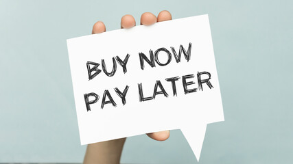 Buy now pay later text concept write on paper in hand