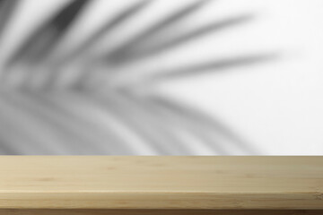  Flat lay  background. Minimal blurred background with shadows of palms and empty wooden table.