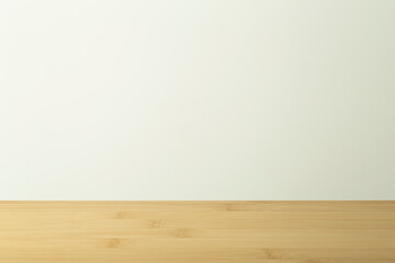 Empty wooden table with white background. Light background with a table for objects and labels.