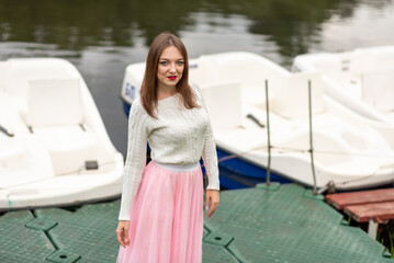 The girl on the pier with catamarans