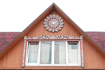 Facade of attic, exterior of roof room with wide window. Wooden house or summer cottage home with carvings and ornaments. Architecture in rural area or countryside. Russian dwelling style and culture