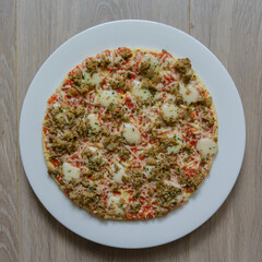 pizza bolognese on a  white plate, top view
