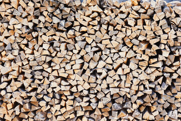 Stacks of firewood in the sawmill. Pile of firewood. Firewood background