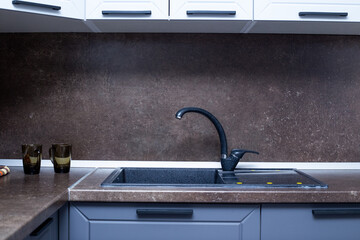 countertop with built-in sink made of black artificial stone, kitchen interior