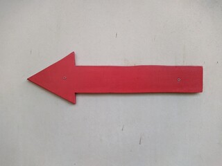 red wooden arrow pointing to the left