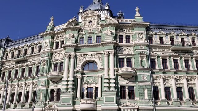 Gorgeous stucco columns and relievo details of antique architecture after renovation in European city. Ornate facade of baroque building after restoration