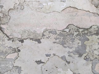 Obraz premium old and battered in places cracked white concrete