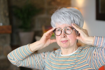 Senior woman experimenting a headache 
