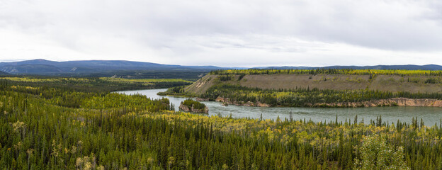 Panoramic View of Scenic River and Trees on a Clear Fall Day in Canadian Nature. Aerial Shot. Taken near the Klondike Highway, Yukon, Canada.